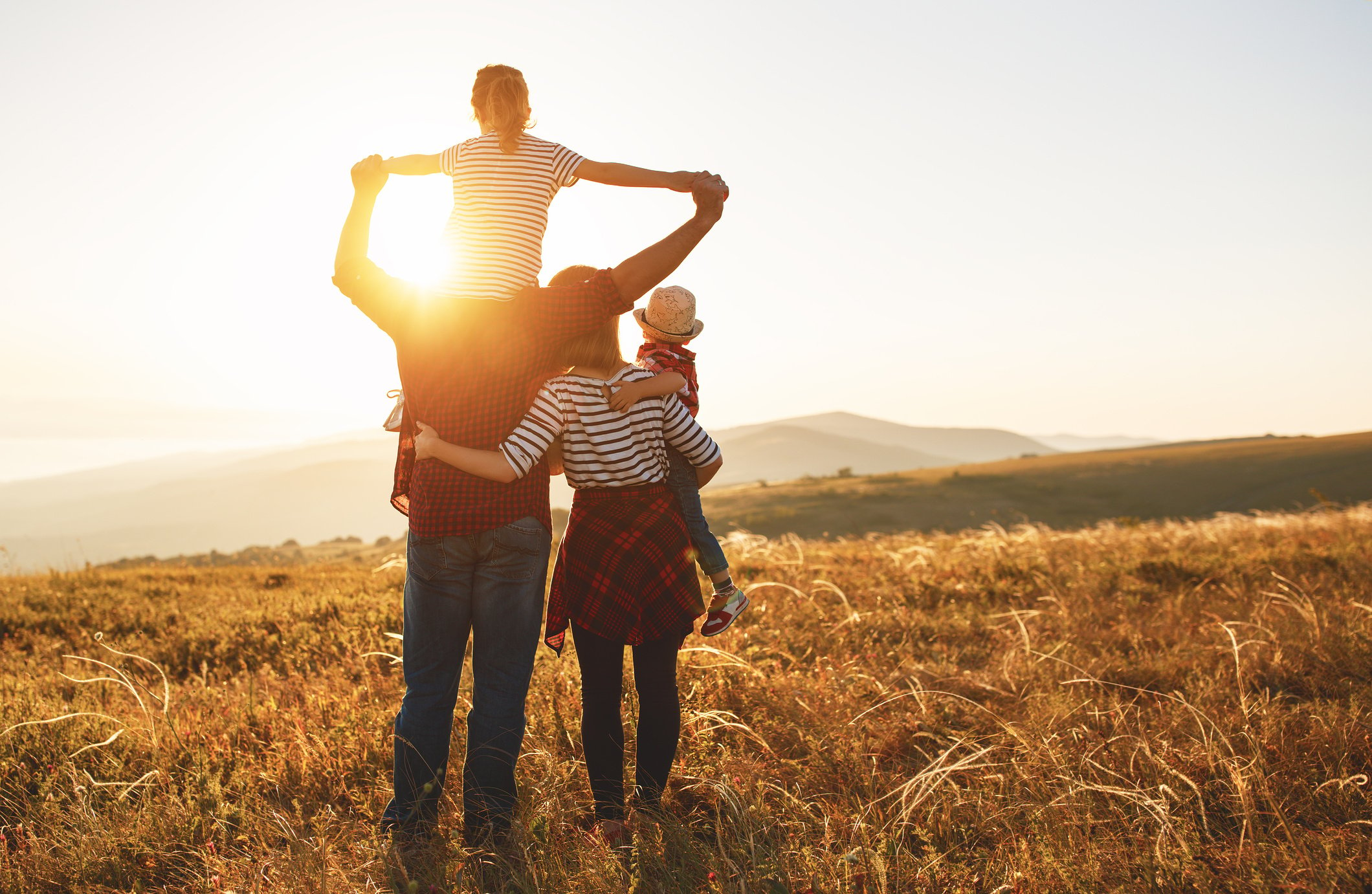 Happy family: mother, father, children son and daughter on sunset